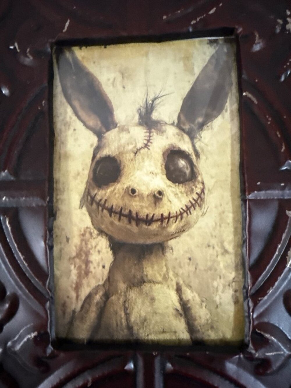 gothic-style print of an eerie, stitched-together stuffed animal creature with